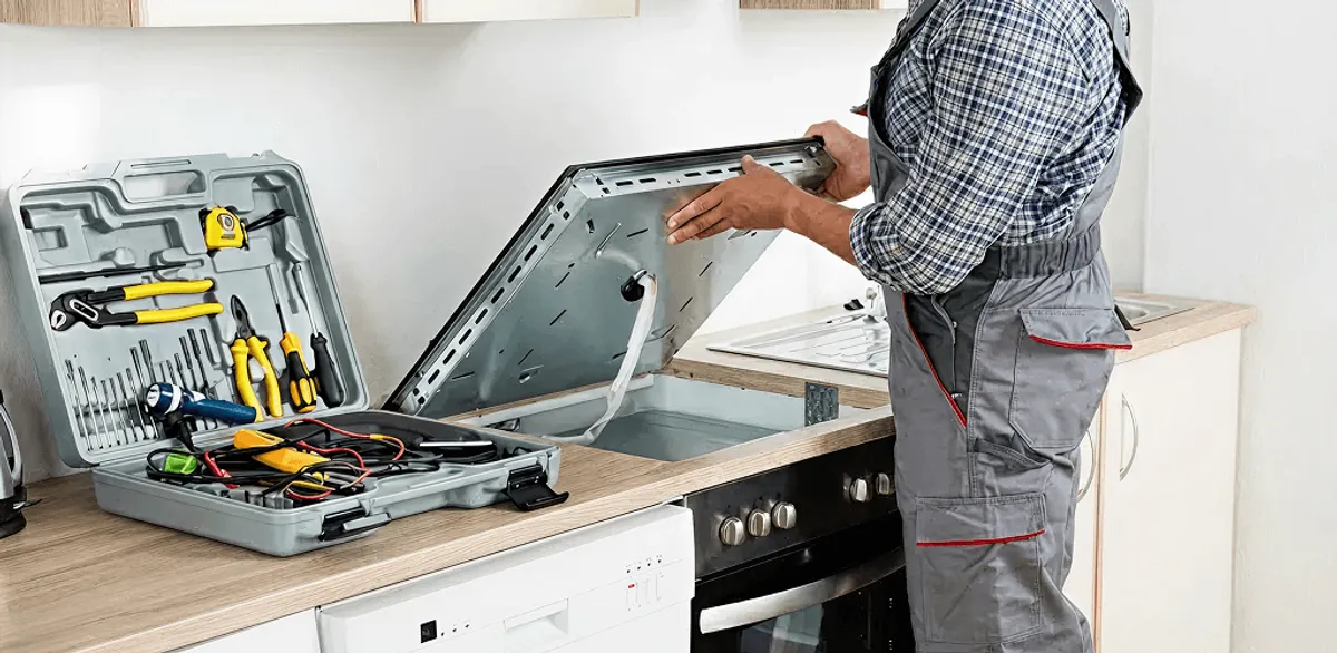 Handyman repairing a cooktop and checking wiring connections in Tucson, AZ