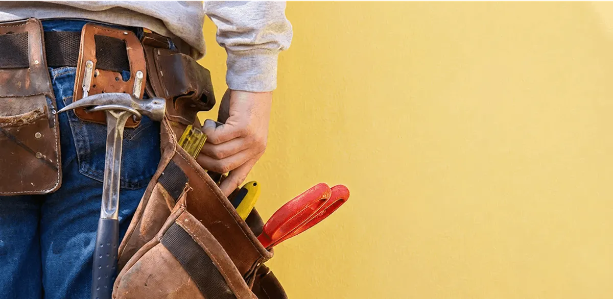 Handyman with tool belt ready for home repairs and maintenance in Tucson, AZ